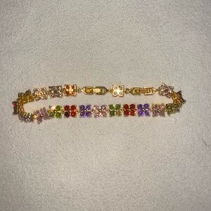 Gold bracelet with multi colored flower charms